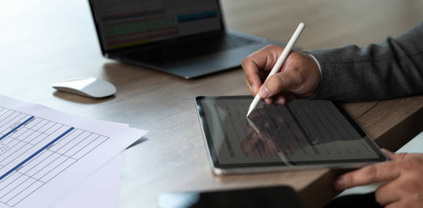 istock businessman uses a pen Signing The Digital Contract On Tablet 2133975302