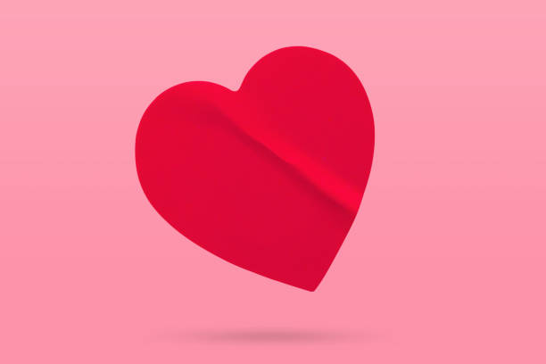 istock Red color heart shape sticker isolated on pink background 2133991968