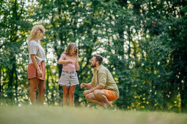 istock A father is crouching in nature and looking at daughter's injured hand 2133994786