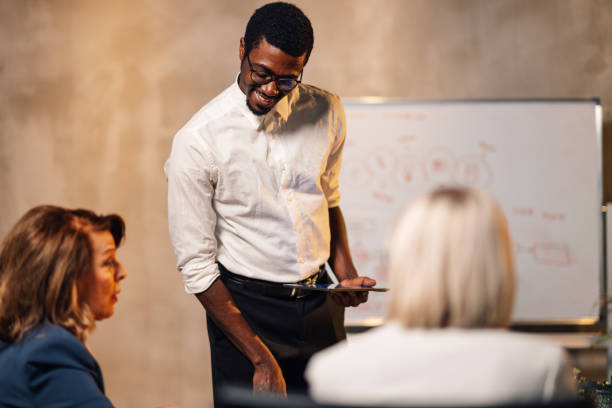 istock Interracial leader with tablet having seminar at boardroom with staff. 2133995299