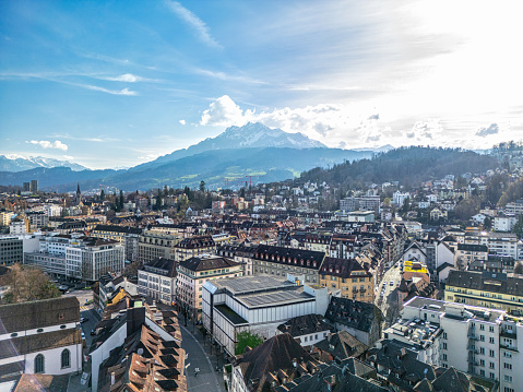 Stunning aerial panorama view of Thun cityscape from Thun Castle with snow covered mountain peaks of Swiss Alps on Bernese Oberland in background, a sunny autumn day, Thun, Canton of Bern, Switzerland