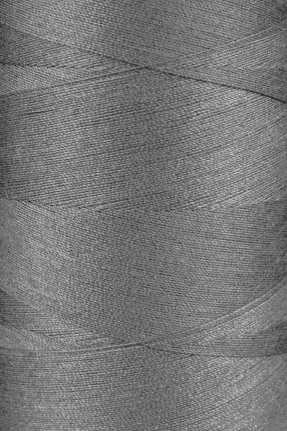 istock Texture of gray color threads in spool close up, macro 2134098324