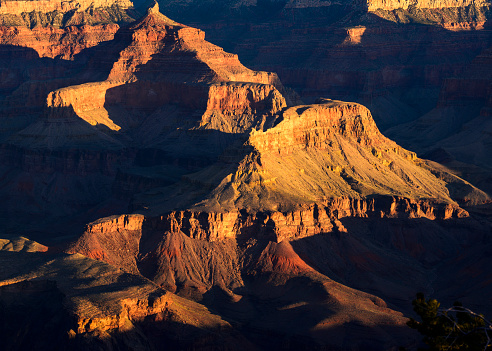 Dappled light hits the bottom of the Grand Canyon at sunrise. Photographed from Mather Point on the South Rim of the Grand Canyon, Arizona.