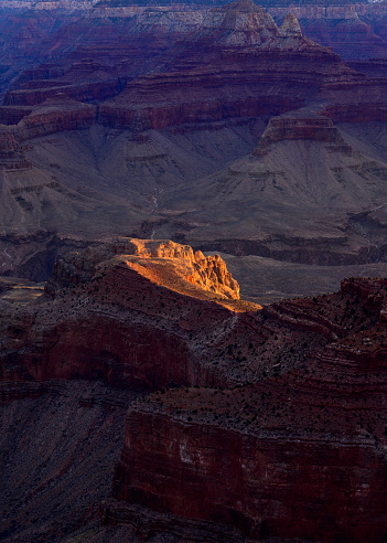 Dappled light hits the bottom of the Grand Canyon at sunrise. Photographed from Mather Point on the South Rim of the Grand Canyon, Arizona.