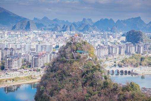 Overview of mountainous Guilin city at noon with sunset cloud. Blue sky with copy space for text