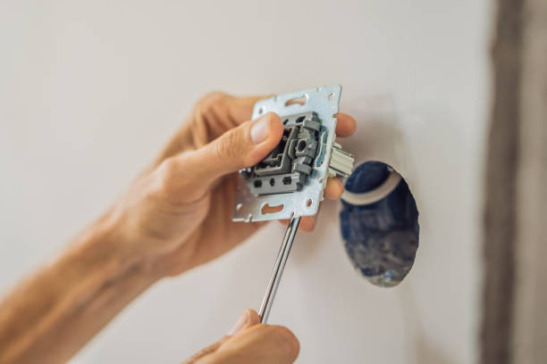 master electrician installs a socket in the house - mounted guard ストックフォトと画像