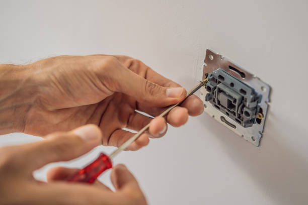istock Master electrician installs a socket in the house 2134171655