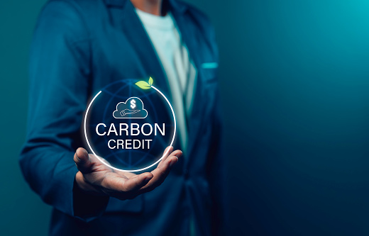 Businessman uses technology to exchange carbon credits Zero net greenhouse gas emissions target Carbon footprint reduction, CO2 emissions, low emissions