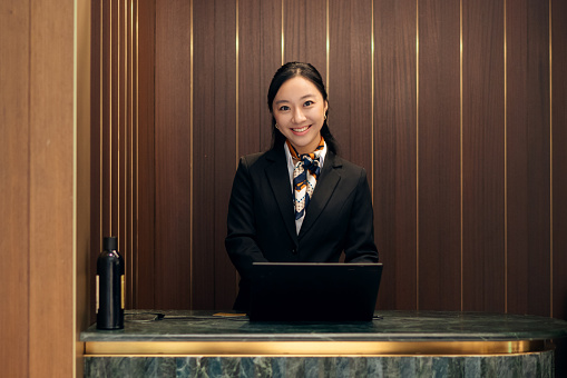 Portrait of an airport lounge concierge staff smiling to camera
