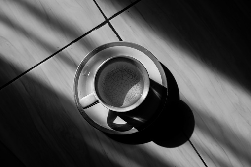 a cup exposed to sunlight in a dark room