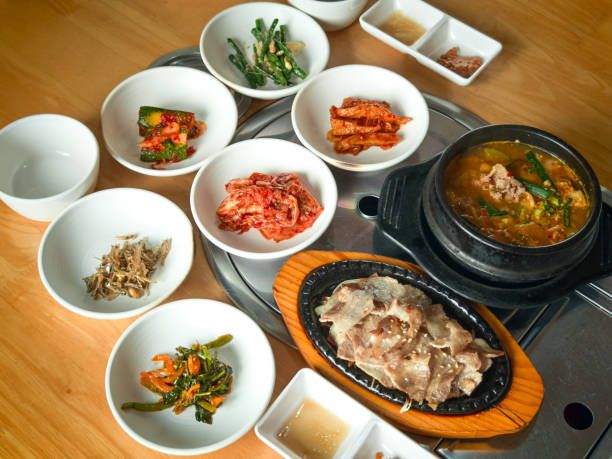 Korean grilled sliced meat and soy bean paste soup with side dishes. HIgh angle view.