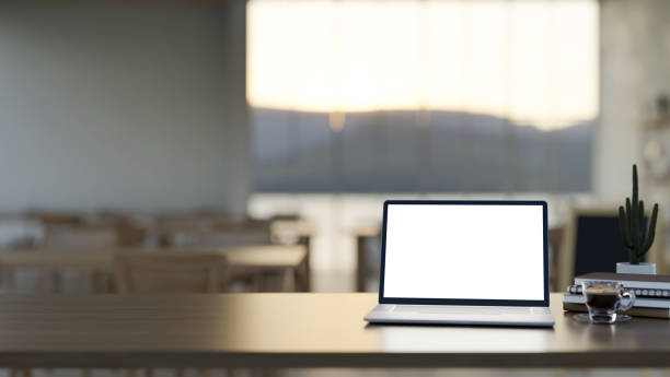 istock A laptop computer white-screen mockup on a wooden desk in a comfortable and contemporary restaurant. 2134394312
