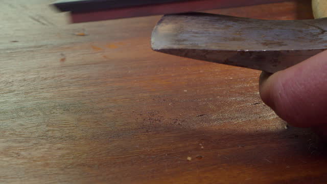 Burrs removed from well-used old axe head using sharpening stone