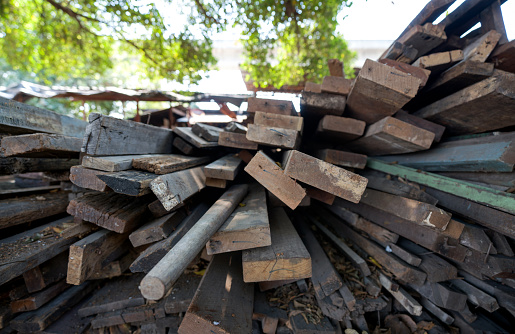 A pile of old wooden planks and logs
