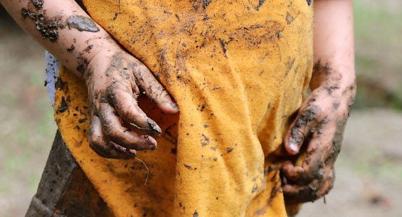 Dirty hands of a child playing outdoors