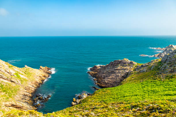 Stones and rocks on Aguino coast with Salvora Island at background