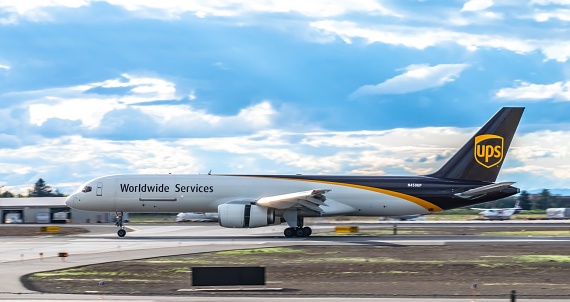 A UPS Boeing 757F using reverse thrust to slow down on the runway, right after landing at the Spokane International Airport, USA, from their main hub at the Louisville, Kentucky USA Airport.