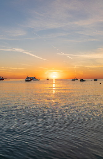 Sunrise over the sea. Panoramic seascape. Burning sky and shining golden waves. Sun over sea