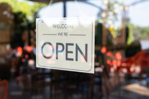 istock A sign hanging from a window that says Welcome We're Open 2134520883