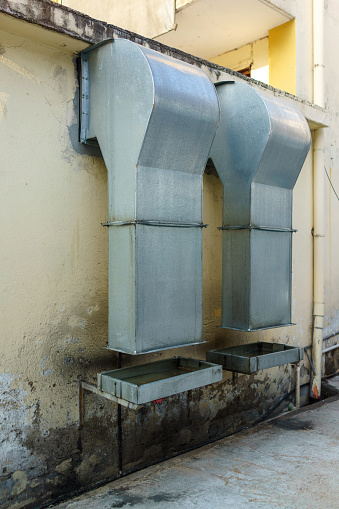 Two large commercial kitchen exhaust hoods are located in the restaurant's back lane.