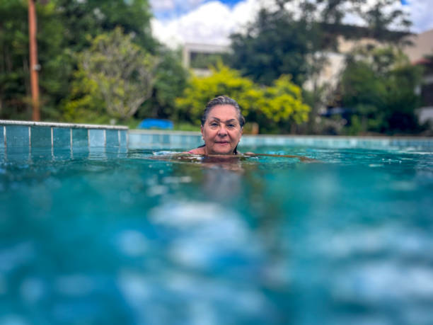 istock Senior Hispanic woman in swimming pool 2134545751