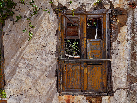 Old, rotten window on an abandoned, dilapidated house.