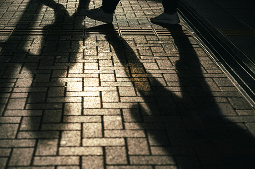 Shadows of people crossing Tokyo's shopping streets