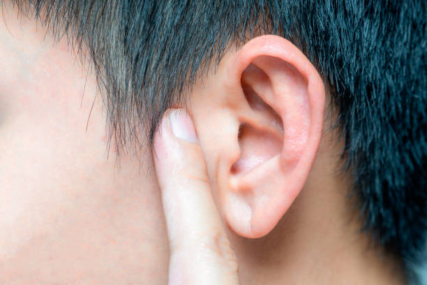 istock The young man touched his ear and he had a sore ear. 2134622111