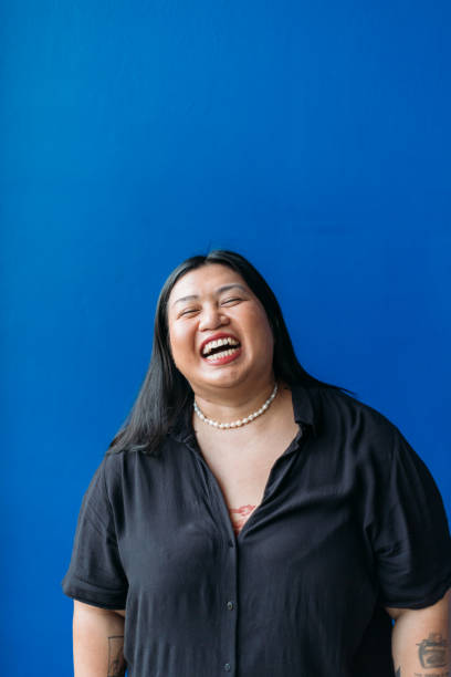 istock Smiling Woman Against Blue Wall 2134649922