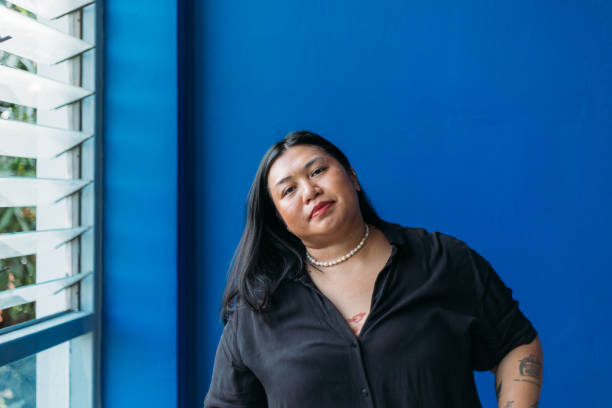 istock Woman Leaning To Side Next to Office Window 2134650459