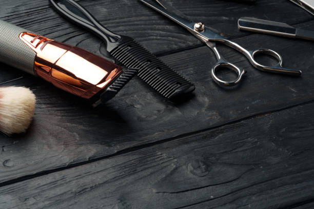 Professional Barber Tools Laid Out on Dark Wooden Surface
