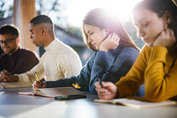 istock Female student writing an exam on a class in the classroom. 2134660632