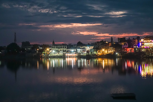Pushkar Holy Lake during twilight with beautiful and colorful city lights reflecting on the lake, is one of the sacred pilgrimage sites in Hinduism