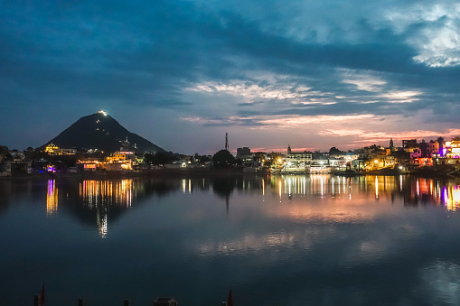 Pushkar Holy Lake during twilight with beautiful city lights reflecting over the lake, is one of the sacred pilgrimage sites in Hinduism
