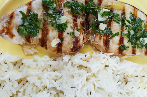 Dish with grilled swordfish and rice as a side dish. Healthy food concept. Directly above.