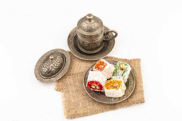 istock Turkish Coffee with Turkish Delight on authentic metal plate, isolated on white background 2134697872