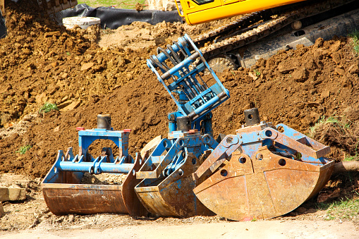 Excavator buckets on a construction site.