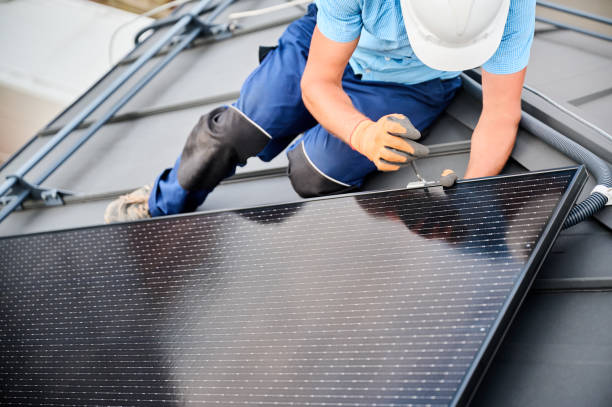 istock Worker building photovoltaic solar panel system on rooftop of house with help of hex key. 2134722017