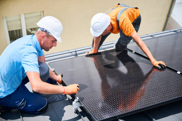 istock Workers building solar panel system on roof of house. Men installing photovoltaic solar module 2134722565