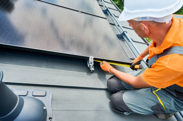 istock Worker building photovoltaic solar panel system, using ruler to measure mounting equipment. 2134723095