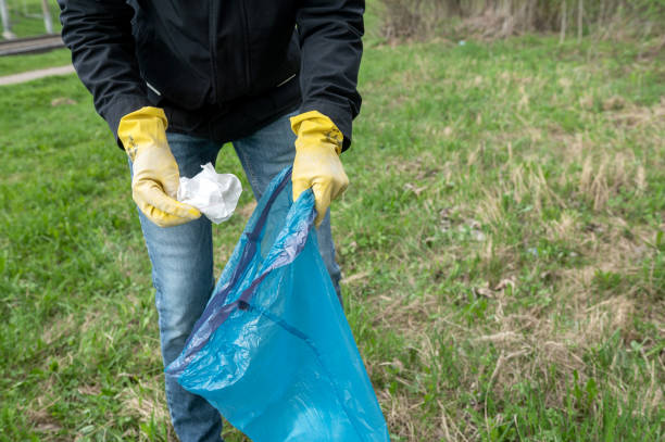 istock Person Picking Litter with Yellow Gloves 2134736926