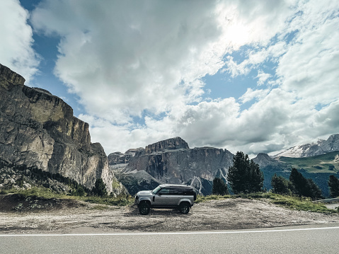 Passo dello Stelvio, Italy - August 25, 2021 : The New Land Rover Defender against the Alps peaks in the north of Italy