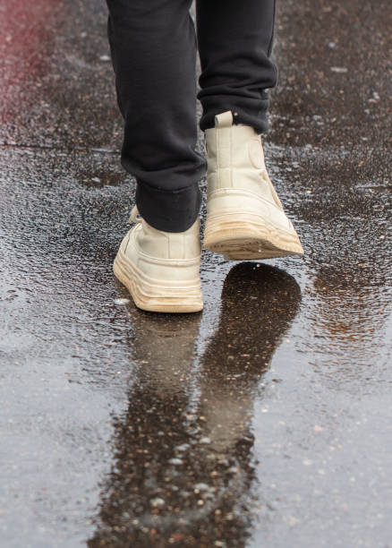 istock A man walks through a puddle on a cold winter day 2134795042