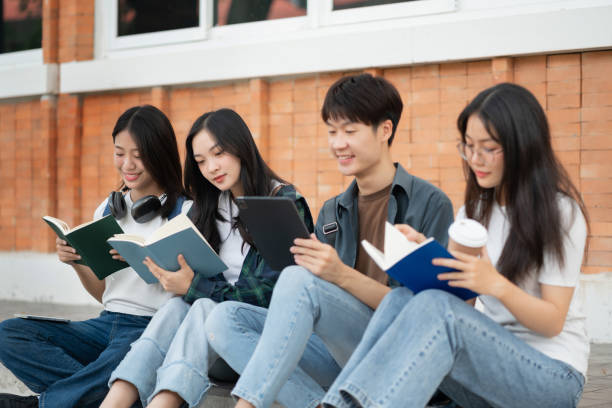 istock Asian students joining study book, smiling with laptop computer tablet at high school university, college, vacation, summer vacation. 2134807587
