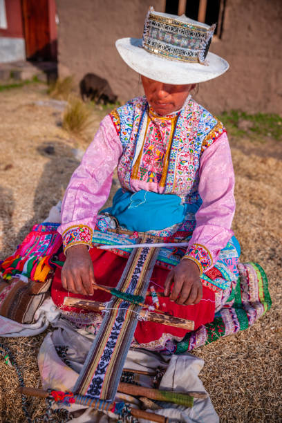 istock Peruvian woman weaving near Colca Canyon, Peru 2134811837