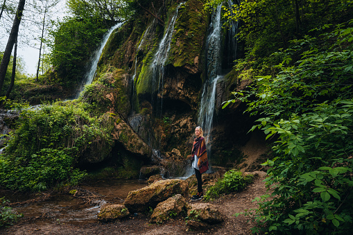 Woman looking at a scenic view of a waterfall.
