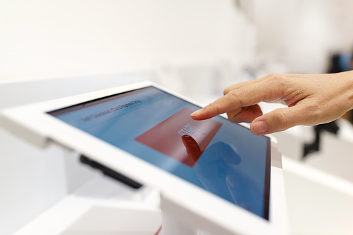 Hands holding digital tablet with blank screen on white background
