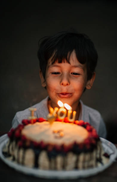 istock A boy blows out candles on his fifth birthday 2134837403