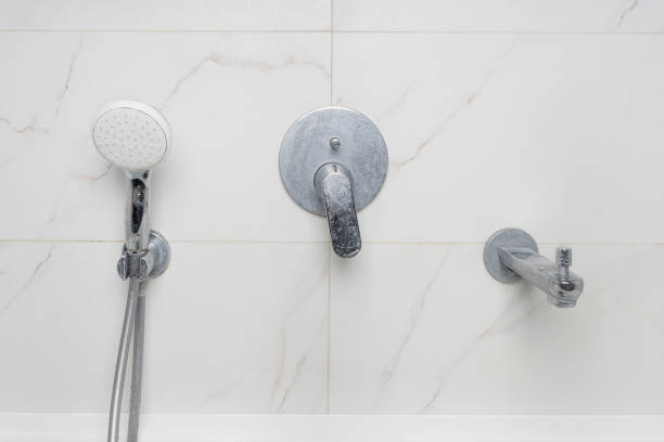 dirty shower faucet covered in limescale and soap stains