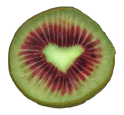 Red kiwifruit with a heart shaped core. Fruit with high antioxidants. Healthy eating or love concept. Produce of New Zealand. Isolated on white.
